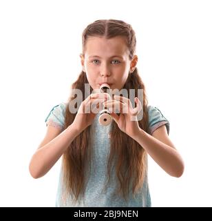 Petite fille jouant à la flûte, isolée sur blanc Banque D'Images