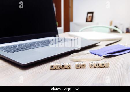 station de travail improvisée à la maison avec ordinateur et masque de protection, concept d'entrepreneur en ligne et travail à distance en raison de la pandémie Banque D'Images