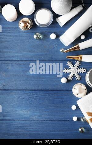 Produits cosmétiques de beauté avec décoration de Noël sur fond bleu en bois Banque D'Images