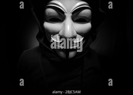 Saint-Pétersbourg - Russie - 25 décembre 2019 - personne anonyme dans le masque Guy Fawkes sur fond noir. Ce masque est un symbole bien connu pour le en ligne Banque D'Images