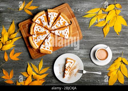 Délicieux gâteau de citrouille en tranches avec décoration crème sur planche à découper en bois Banque D'Images