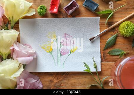 Peinture aux aquarelles avec fleurs sur table en bois Banque D'Images