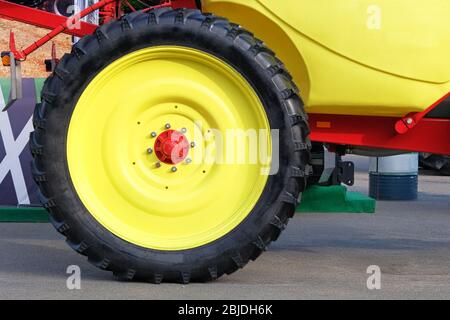 Roue jaune du tracteur, gros plan. Agronomie, agriculture, concept d'élevage. Banque D'Images