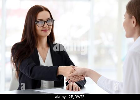 Concept d'entretien de poste. Responsable des ressources humaines secouant la main de la femme, à proximité Banque D'Images