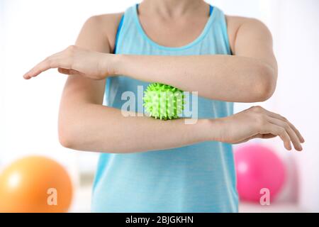 Femme faisant des exercices avec boule de caoutchouc dans la clinique, la proximité Banque D'Images