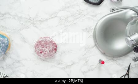 Étape par étape. Mise à plat. Le mélange colorant alimentaire dans la pâte à biscuits à cuire, rouge, blanc et bleu sucre pinwheel cookies. Banque D'Images