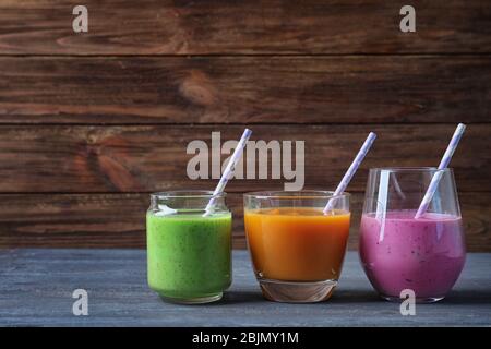 Verres avec smoothie yummy sur fond en bois Banque D'Images