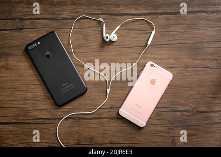 KIEV, UKRAINE - 24 OCTOBRE 2017: IPhone 7 plus Noir et iPhone 6 S Rose Gold avec écouteurs sur fond de bois Banque D'Images