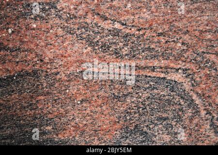 Gros plan d'une surface de granit poli de type rouge multicolore utile pour certains arrière-plan texturé marbré Banque D'Images