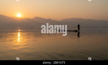 Nyaungshwe, Myanmar : 12 mars 2020 - poissons pêcheurs avec filet Inle Lake, deuxième plus grand, au lever du soleil. Silhouette à l'heure d'or au coucher du soleil Banque D'Images