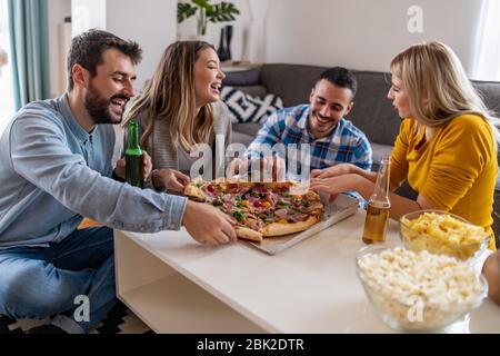 Amis s'amuser à la fête avec de délicieuses pizzas.les gens partagent la pizza. Commençons par le parti. Banque D'Images