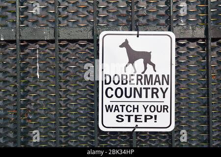 Gros plan sur un panneau attention aux chiens qui dit : « oberman Country, regardez votre pas ! » Sur la porte d'entrée d'une maison, Italie Banque D'Images