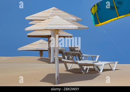 Parasols en bois et sièges inclinables vides / chaises de plage à la plage de Rabil, île Boa Vista, Cap-Vert / l'archipel de Cabo Verde dans l'océan Atlantique Banque D'Images