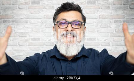 Homme senior branché de course mixte s'amusant à prendre selfie Banque D'Images