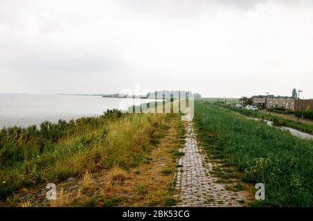 Temps pluvieux sur la mer, où la côte avec herbe verte est visible Banque D'Images