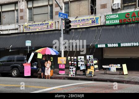 Los Angeles, CA/USA - 28 avril 2020: Un vendeur de rue vendant des masques de visage pendant l'épidémie de coronavirus Banque D'Images