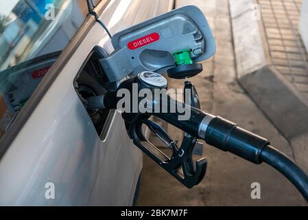 Gros plan sur le gicleur de pompe à gaz qui remplit une voiture diesel Banque D'Images