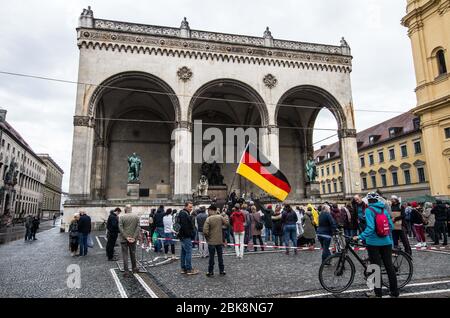 Munich, Bavière, Allemagne. 2 mai 2020. Le drapeau allemand est agité lors d'une manifestation de complot à Munich, en Allemagne. Après une violente attaque contre les journalistes de la ZDF à Berlin, les hygiénedemos de Munich ont eu lieu à nouveau, avec des théoriciens du complot, des extrémistes de droite, des néonazis, des Hooligans, des membres de l'AFD, des insultes et des agressions contre les journalistes et la police, ainsi que des violations des lois sur la protection contre les infections. Organisé dans des discussions par télégramme par des groupes conspirateurs 'Querfront' (cross-front), les organisateurs ont planifié plusieurs démos individuelles avec des instructions pour finalement passer à un centir Banque D'Images