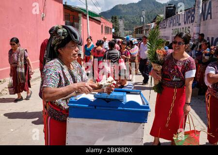 Femme vêtue du costume typique coloré de la communauté Ixil qui vend de la crème glacée dans les rues de Nebaj. Banque D'Images