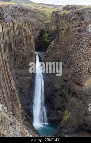 La superbe cascade de Litlanesfoss où l'eau tombe entre la géologie massive de la colonne de basalte, l'Islande. Banque D'Images