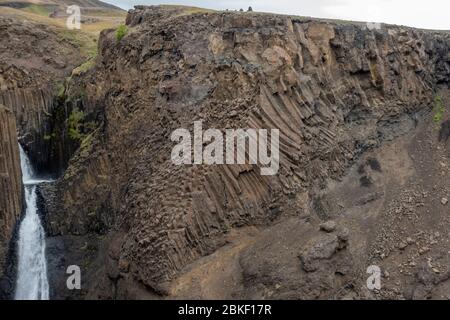 Détail de la géologie massive de la colonne de basalte de la superbe cascade de Litlanesfoss, où l'eau tombe entre, l'Islande. Banque D'Images