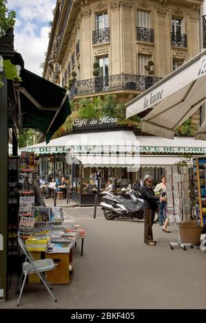 StreetScene à Paris , Boulevard StGermain avec café de flore en arrière-plan et un stand de papier sur la gauche au premier plan, Paris, France Banque D'Images