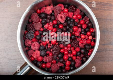 Assortiment de baies rouges congelées dans une casserole en métal Banque D'Images