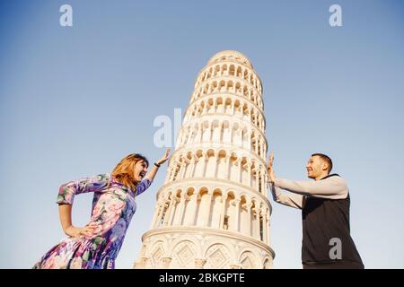 Un couple aimant prend une photo selfie sur le bâton et l'appareil photo contre fond de la tour penchée Pise, Italie. Concept de voyage. Banque D'Images