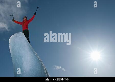 Femme grimpez l'iceberg sur le lagon du glacier de Fjallsjoull Banque D'Images