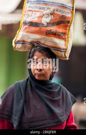 Inde, Rajasthan, Bundi, femme portant un sac sur sa tête Banque D'Images