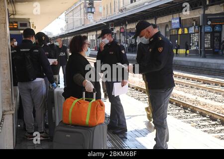 Bologne, Italie. 4 mai 2020. Les policiers vérifient les passagers à la gare centrale de Bologne à Bologne, en Italie, le 4 mai 2020. La pandémie de coronavirus a coûté la vie à plus de 29 000 personnes en Italie, portant le nombre total d'infections, de morts et de reprises à 211 938 lundi, selon les dernières données publiées par le Département de la protection civile du pays. Les Italiens ont plus de libertés lundi, car certaines restrictions sur les activités productives et les mouvements personnels ont été assouplies pour la première fois après presque huit semaines. Crédit: Gianni Schicchi/Xinhua/Alay Live News Banque D'Images