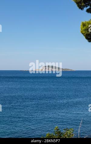 Bobara petite île près de Cavtat, Dalmatie Croatie par une journée ensoleillée en été entourée par la mer et le ciel bleu cristal. Îlot de forme unique au sud Banque D'Images