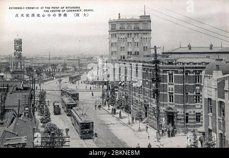 [ années 1920 Japon - quartier des affaires de Kitahama, Osaka ] — cette carte postale des années 1920 montre le quartier des affaires de Kitahama à Osaka. Le photographe se pensa vers le pont de Naniwabashi, qui est en partie visible. Le bâtiment en briques sur la droite est la Bourse d'Osaka (大阪株式取引所). La grande structure à l'arrière est le bâtiment Kitahama (北浜ビルジング). carte postale vintage du xxe siècle. Banque D'Images