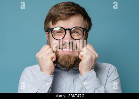 Homme en stress en raison de sa barbe et de sa coiffure déchiquetée, il n'était pas dans un salon de coiffure depuis longtemps. Concept de quarantaine. Banque D'Images