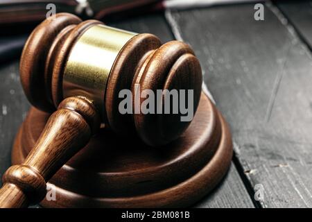 Le gavel du juge sur une table en bois dans l'obscurité Banque D'Images