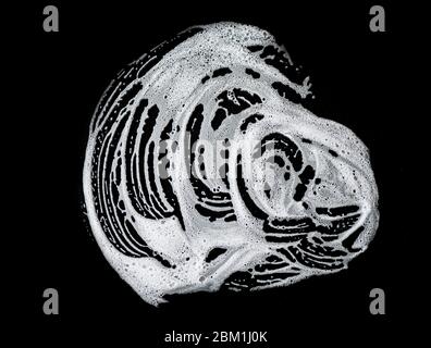 Mousse de savon blanc sur fond noir, bulles de savon, texture Banque D'Images