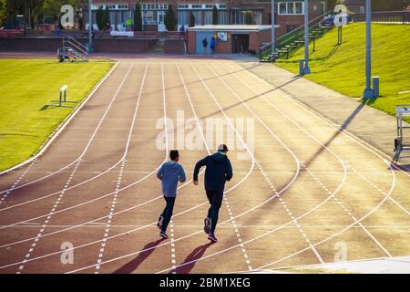 Vue arrière de personnes non identifiées qui s'exécutent sur le Parliament Hill Fields Athletics Track à Hampstead Heath à Londres Banque D'Images