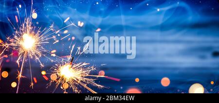 Sparklers avec fumée et bokeh sur fond de bois - concept de célébration de jour d'indépendance Banque D'Images