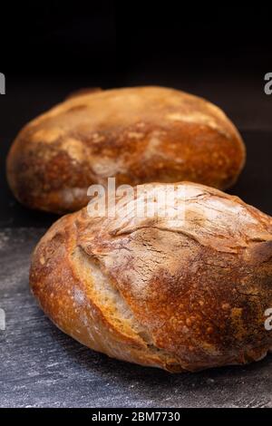 Ambiance sombre et ton maison cuisine maison biologique rustique Sourdough pain sur fond noir avec espace de copie Banque D'Images