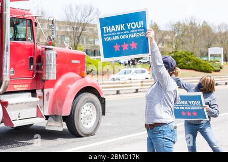 Concord, Massachusetts. 8 mai 2020. Les femmes tiennent des panneaux de remerciement à la circulation routière par l'hôpital Emerson à Concord pendant la Parade Appréciation. Banque D'Images