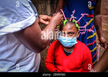 Nairobi, Kenya. 09e mai 2020. Martha APISA, 12 ans, ayant des touches finales de son style de tresse du virus Corona qui crée la conscience pendant la pandémie du virus corona. Le Kenya a enregistré 649 cas confirmés, 207 cas de rétablissement et 30 décès dus à la maladie de Covid 19. Crédit : SOPA Images Limited/Alamy Live News Banque D'Images