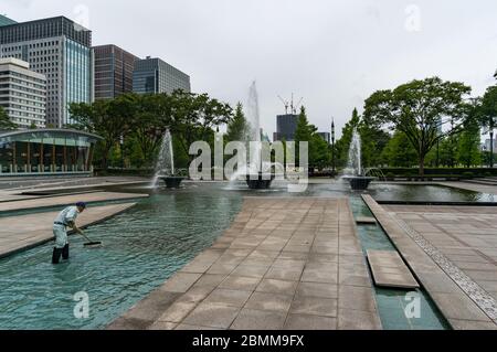 Tokyo, Japon - 30 août 2016 : nettoyage des fontaines de Wadakura dans la banlieue de Marunouchi, Tokyo, Japon. Homme au travail, entretien des lieux publics Banque D'Images