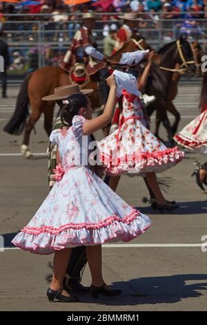 Groupe de danse traditionnelle cueca qui se présente au défilé militaire annuel dans le cadre des commémorations Fiestas Patrias à Santiago, au Chili. Banque D'Images