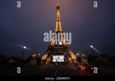 Paris, France. 10 mai 2020. Des portraits de représentants de groupes professionnels mobilisés pendant la pandémie COVID-19 sont présentés lors d'un hommage sur un écran géant devant la Tour Eiffel à Paris, France, le 10 mai 2020. Crédit : Jack Chan/Xinhua/Alay Live News Banque D'Images