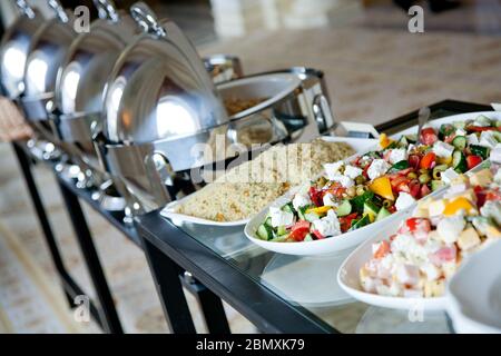 table en verre de banquet couverte de salades sur des assiettes blanches Banque D'Images