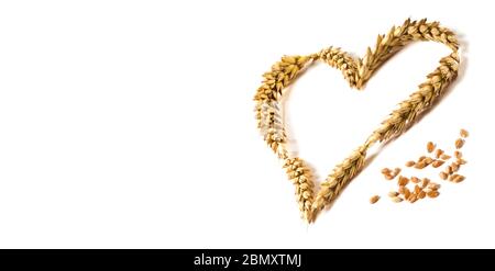 L'amour mûr - forme de coeur fait de tiges de blé doré isolé sur fond blanc comme un élément de conception pour l'amour et les thèmes harwest. Prise de vue en studio. Banque D'Images