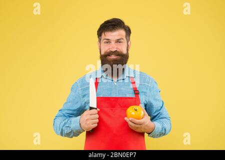 Recette de salade fraîche. Coupe sûre. Couper des légumes. Liste ultime des techniques de coupe que chaque chef devrait savoir. Le chef prépare le repas. Homme barbu préparer la tomate. Homme mature tient le couteau et le légume. Banque D'Images