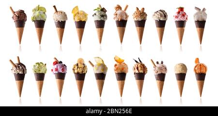 Plusieurs saveurs de boules de crème glacée décorées de fruits et de gaufrettes sur un cône de chocolat semi-trempé Banque D'Images