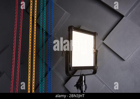 Lampe LED sur trépied dans studio photo. Lampe vidéo professionnelle sur support réglable. Lampe photo et vidéo sur fond de mur gris en relief. Fermer-u Banque D'Images