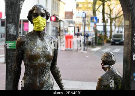 ALLEMAGNE, Hambourg, Ottensen, Corona virus, COVID-19 , Ottenser Torbogen, deux femmes sculpture de l'artiste Doris Waschk-Balz , quelqu'un a mis un masque de protection pour les protéger de Covid-19 Banque D'Images